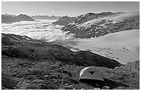Camping in tent above glacier and sea of clouds. Kenai Fjords National Park, Alaska, USA. (black and white)