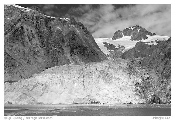 Northwestern tidewater glacier and steep cliffs, Northwestern Fjord. Kenai Fjords National Park, Alaska, USA.