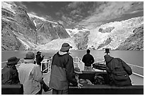 Passengers on the deck of tour boat and Northwestern glacier, Northwestern Lagoon. Kenai Fjords National Park, Alaska, USA. (black and white)