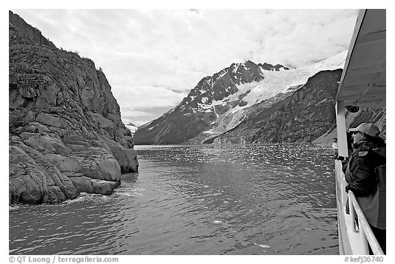 Passenger on small tour boat, island and glacier, Northwestern Fjord. Kenai Fjords National Park (black and white)