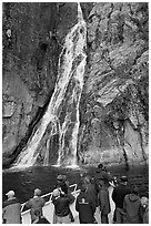 Passengers look at waterfall from tour boat, Cataract Cove, Northwestern Fjord. Kenai Fjords National Park, Alaska, USA. (black and white)