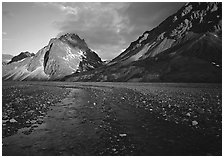 Stream on wide gravel bar and peaks at sunset. Lake Clark National Park ( black and white)