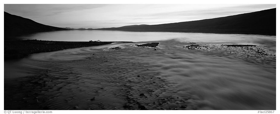 Wide stream flowing into lake at sunset. Lake Clark National Park (black and white)