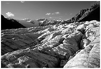 Crevasses on Root glacier, Wrangell mountains in the background, late afternoon. Wrangell-St Elias National Park, Alaska, USA. (black and white)