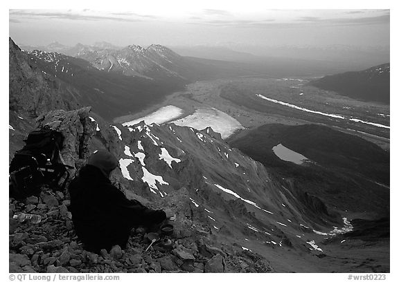 Mountaineer looking down from Donoho Peak. Wrangell-St Elias National Park (black and white)