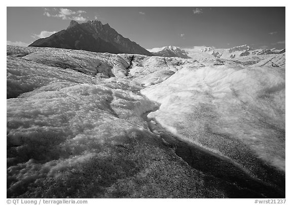 Stream running on surface of Root Glacier and Donoho Peak. Wrangell-St Elias National Park (black and white)