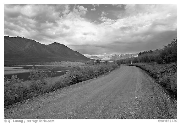 Unpaved McCarthy Road next to lake. Wrangell-St Elias National Park (black and white)