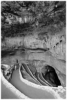 Tourist walking down natural entrance. Carlsbad Caverns National Park ( black and white)