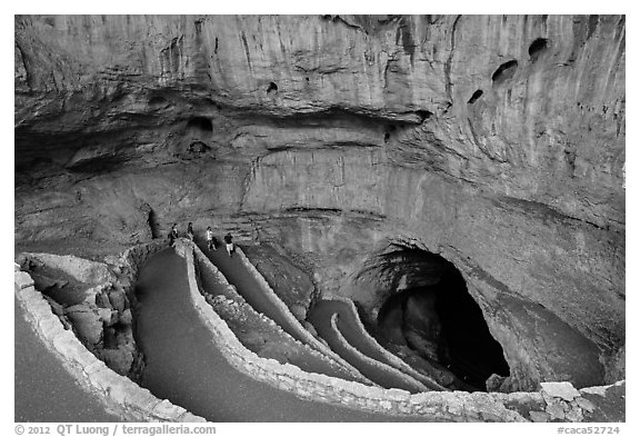 Tourists walking down natural entrance. Carlsbad Caverns National Park (black and white)