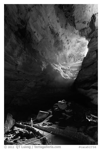 Visitor looking at natural entrance from below. Carlsbad Caverns National Park (black and white)
