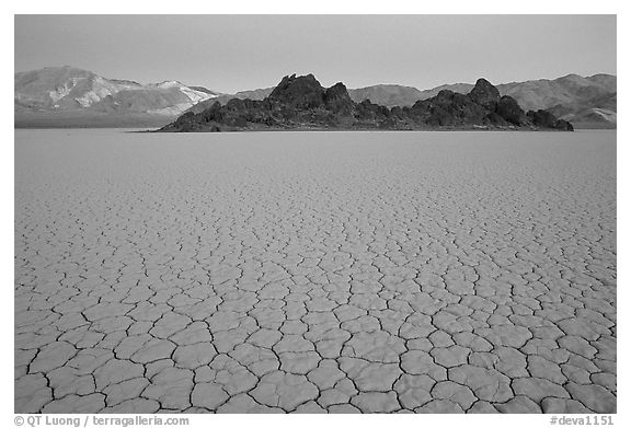 Tiles in cracked mud and Grand Stand, Racetrack playa, dusk. Death Valley National Park (black and white)