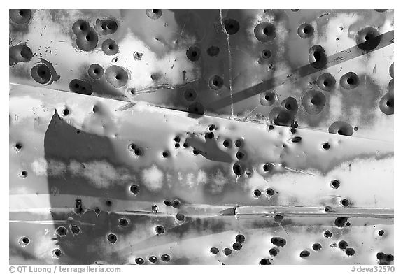 Detail of car with bullet holes near Aguereberry camp, afternoon. Death Valley National Park (black and white)