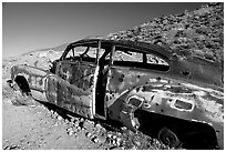 Car with bullet holes near Aguereberry camp, afternoon. Death Valley National Park, California, USA. (black and white)
