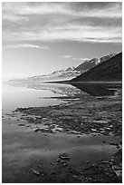 Black mountain reflections in flooded Badwater basin, early morning. Death Valley National Park, California, USA. (black and white)