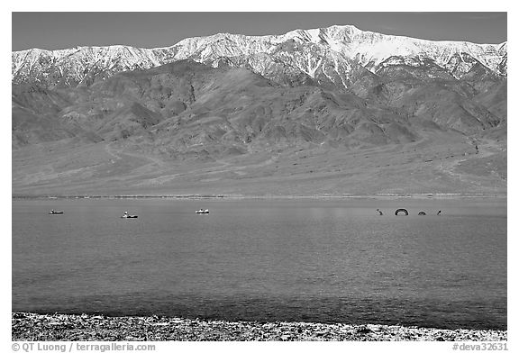 Kayakers padding towards the Loch Ness Monster in Manly Lake, below Telescope Peak. Death Valley National Park, California, USA.