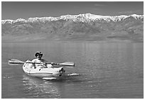 Kayaker padding ephemeral Manly Lake. Death Valley National Park, California, USA. (black and white)