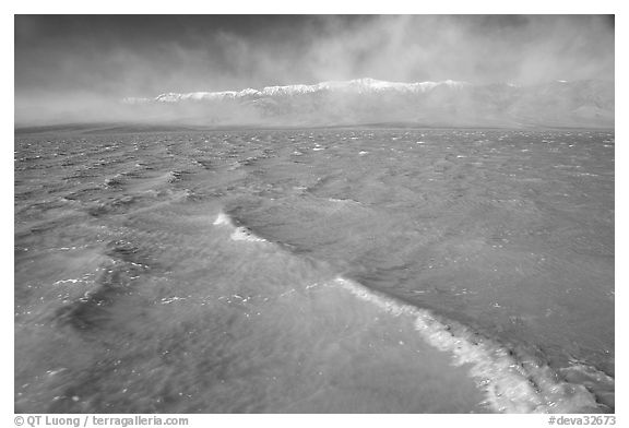Extremely rare waves on mud-colored Manly Lake, early morning. Death Valley National Park (black and white)