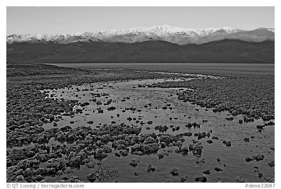 Salt pool and sunrise over the Panamints. Death Valley National Park (black and white)