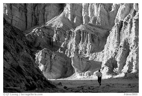 Hikers surrounded by tall walls in Golden Canyon. Death Valley National Park (black and white)