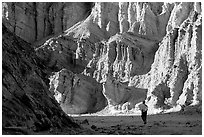 Hikers surrounded by tall walls in Golden Canyon. Death Valley National Park, California, USA. (black and white)