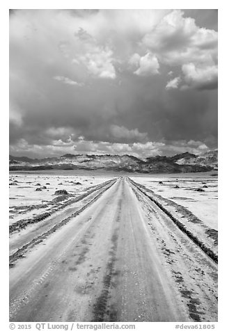 Straight road through Salt Pan. Death Valley National Park (black and white)