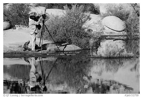 Photographer with large format camera at Barker Dam. Joshua Tree National Park (black and white)