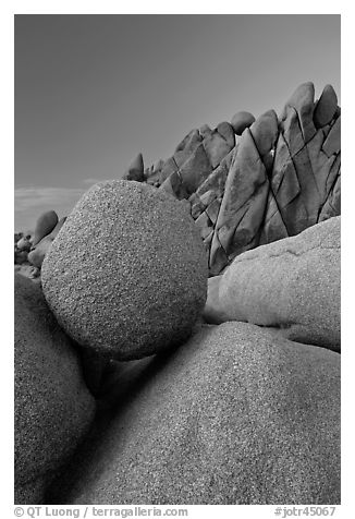 Spherical granite boulder and angular rocks, twilight. Joshua Tree National Park (black and white)