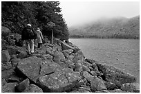 Hikers on shore of Jordan Pond. Acadia National Park, Maine, USA. (black and white)