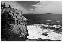 Tall granite sea cliff with person standing on top. Acadia National Park, Maine, USA. (black and white)