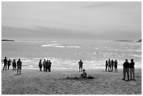 People looking at ocean from Sand Beach. Acadia National Park, Maine, USA. (black and white)