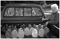 Resident stocks up on natural spring water. Hot Springs National Park, Arkansas, USA. (black and white)