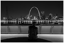 St Louis skyline and Malcom Martin statue from Mississippi River Overlook at night. Gateway Arch National Park ( black and white)
