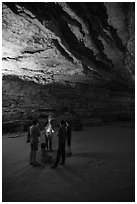 Ranger with lantern talks to family in cave. Mammoth Cave National Park ( black and white)