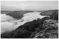 Sunrise over fog-filled gorge from Grandview Overlook. New River Gorge National Park and Preserve ( black and white)