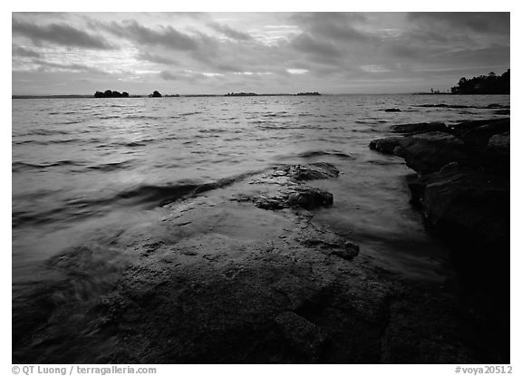 Lakeshore with eroded granite slab and clouds. Voyageurs National Park (black and white)