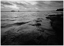 Lakeshore with eroded granite slab and clouds. Voyageurs National Park, Minnesota, USA. (black and white)
