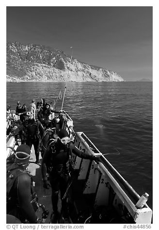 Divers in full wetsuits on diving boat, Santa Cruz Island. Channel Islands National Park, California, USA.
