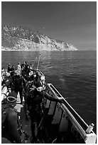 Divers in full wetsuits on diving boat, Santa Cruz Island. Channel Islands National Park, California, USA. (black and white)