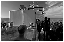 Soaking in hot tub on diving boat, Annacapa Island. Channel Islands National Park, California, USA. (black and white)