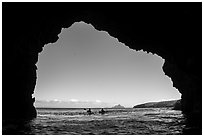 Looking out sea cave entrance with distant sea kayakers, Santa Cruz Island. Channel Islands National Park ( black and white)
