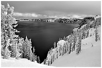 Trees and lake in winter with clouds and dark waters. Crater Lake National Park (black and white)
