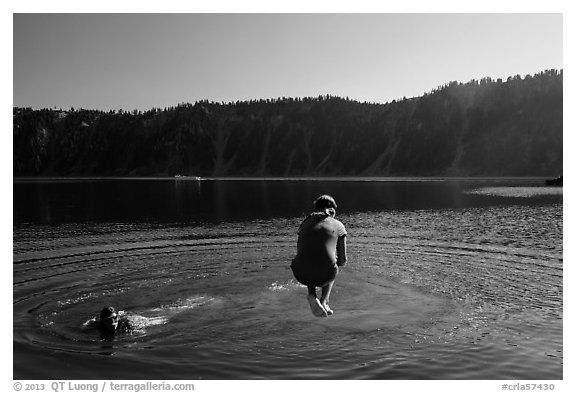 Girl jumps in water in Governors Bay, Wizard Island. Crater Lake National Park (black and white)