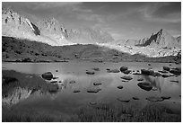 Mt Agasiz, Mt Thunderbolt, and Isoceles Peak reflected in a lake in Dusy Basin, late afternoon. Kings Canyon National Park, California, USA. (black and white)