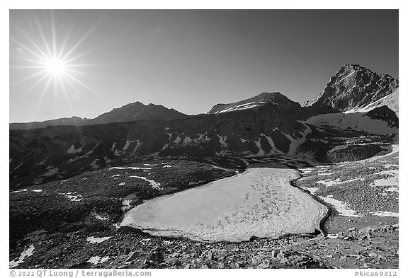 Sun and frozen lake from Forester Pass. Kings Canyon National Park (black and white)