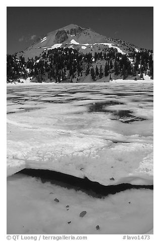 Ice break up in lake Helen and Lassen Peak, early summer. Lassen Volcanic National Park, California, USA.