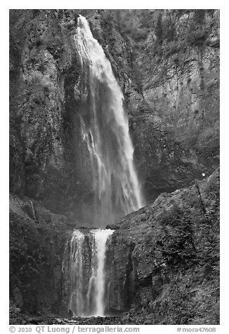 Hiker in the distance gives scale to Comet Falls. Mount Rainier National Park (black and white)