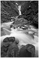 Water flowing over boulders from waterfall. Mount Rainier National Park, Washington, USA. (black and white)