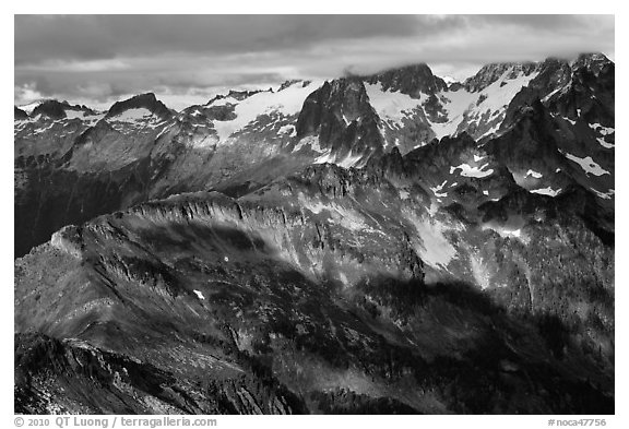 Cloud-capped mountains in dabbled light, North Cascades National Park.  (black and white)