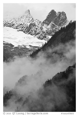 Inspiration Peak and the Pyramid rising above clouds, North Cascades National Park.  (black and white)