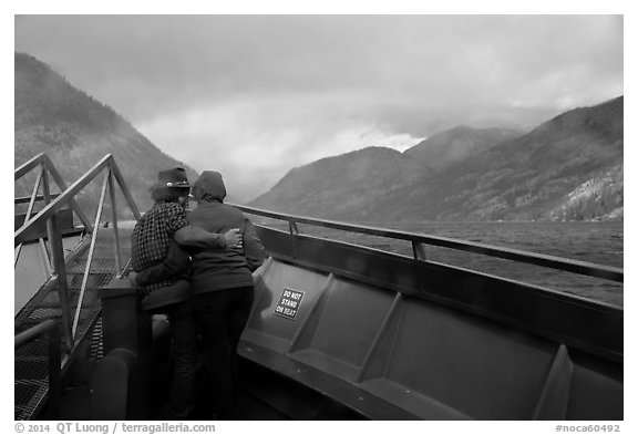 Couple at bow of boat looking at rainbow over Lake Chelan, North Cascades National Park Service Complex.  (black and white)